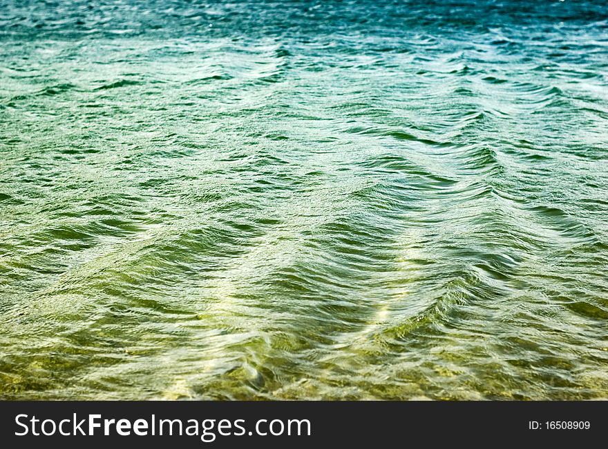 Small ripples on the water. Water color similar to the gradient from green to blue