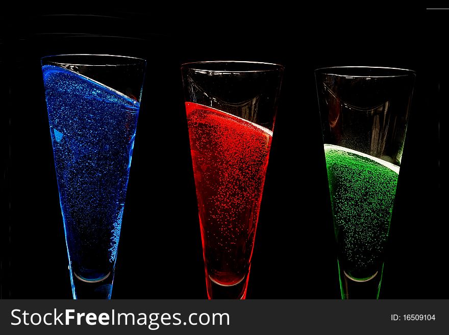 Champagne glasses filled with coloured sparkly win