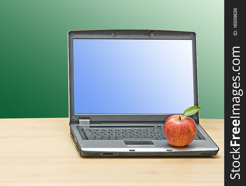 Notebook and apple on desk