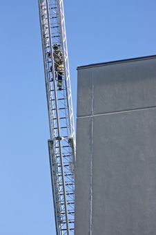 Firefighter Climbing An Aerial Ladder Royalty Free Stock Photography Firefighter Climbing An Aerial Ladder Royalty Free Stock Photography