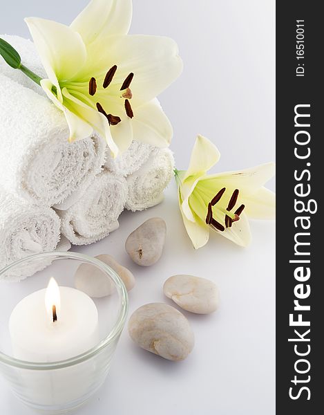 White towels and flower with candle on white bacground. White towels and flower with candle on white bacground