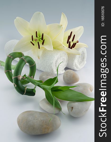White towels and orchid, stones, bamboo on white bacground. White towels and orchid, stones, bamboo on white bacground
