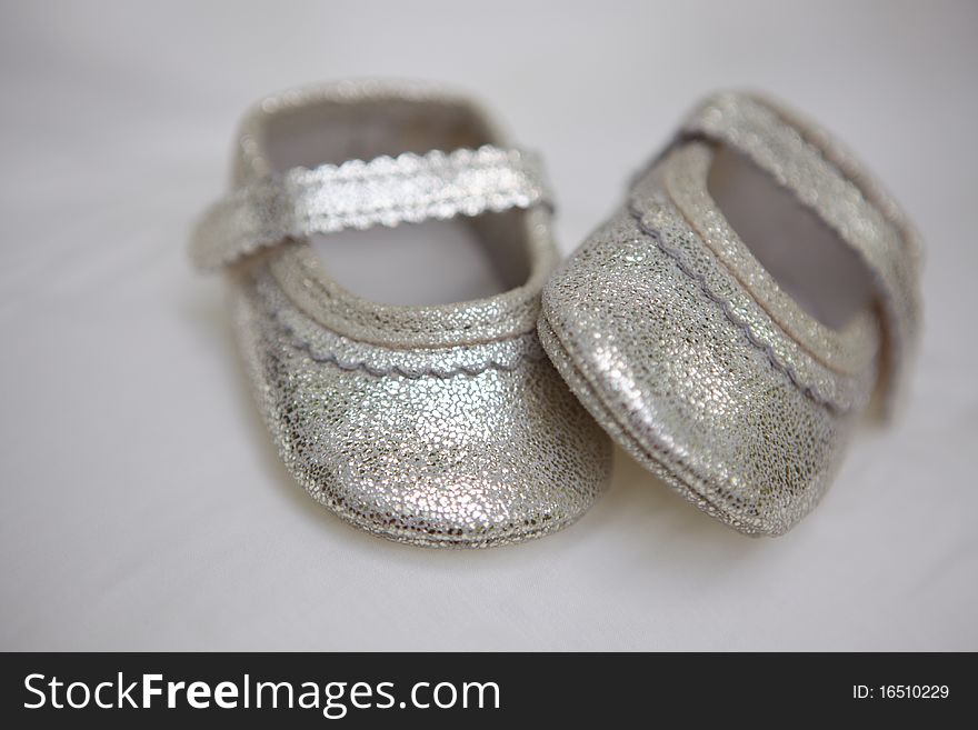 Small silver baby's bootees in studio shot