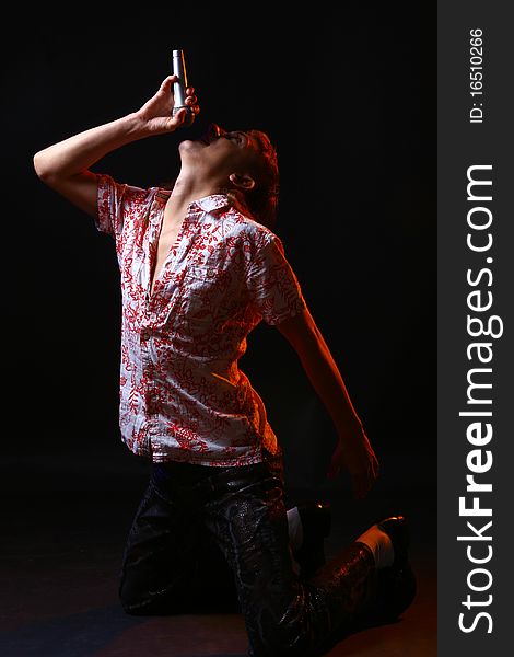 Attractive singing man with silver microphone on black background. Attractive singing man with silver microphone on black background