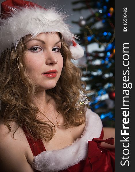 Beauty woman in santa hat wih christmas tree