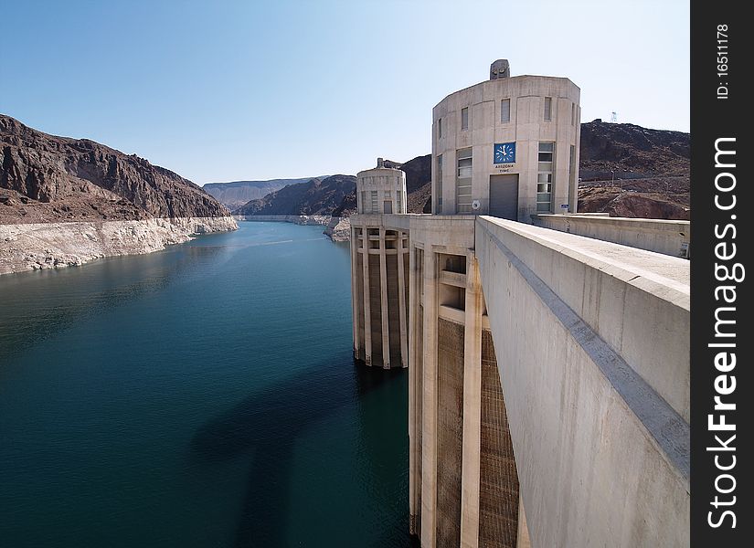 Hoover Dam's sculptured turrets, clock faces on the intake towers set for the time in Arizona. Hoover Dam's sculptured turrets, clock faces on the intake towers set for the time in Arizona.