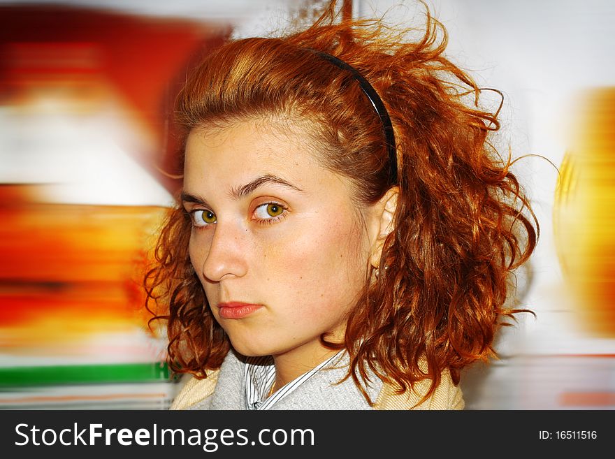 Red-haired girl on blur background