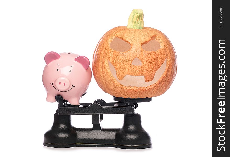 Piggybank and pumpkin on scales