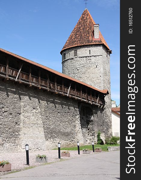 Part of the old city wall with one of the towers in Tallinn - the capital of Estonia. Part of the old city wall with one of the towers in Tallinn - the capital of Estonia