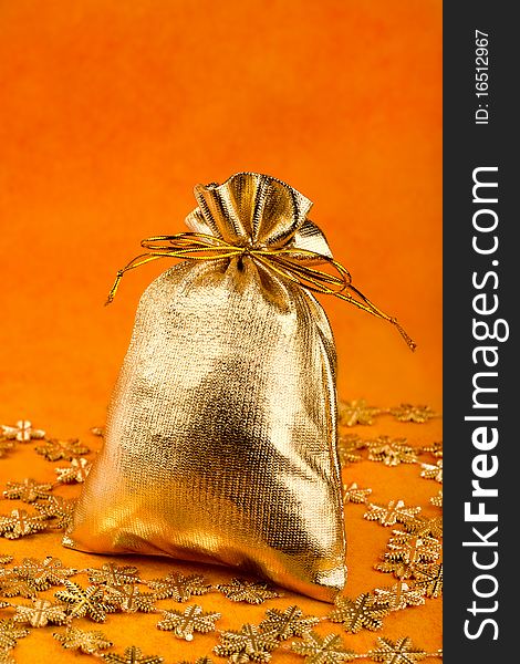 Golden gift sack and golden snowflakes