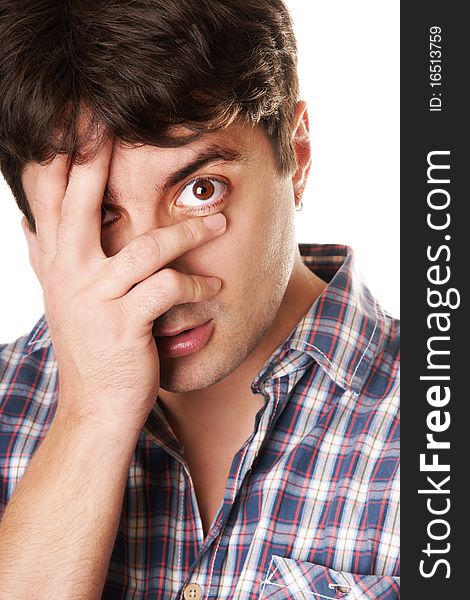 Portrait of young dark-haired grimacing man isolated on white background. Portrait of young dark-haired grimacing man isolated on white background