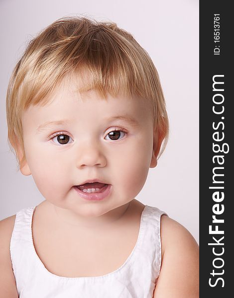 Portrait of smiling baby girl with attentive look, studio shot. Portrait of smiling baby girl with attentive look, studio shot