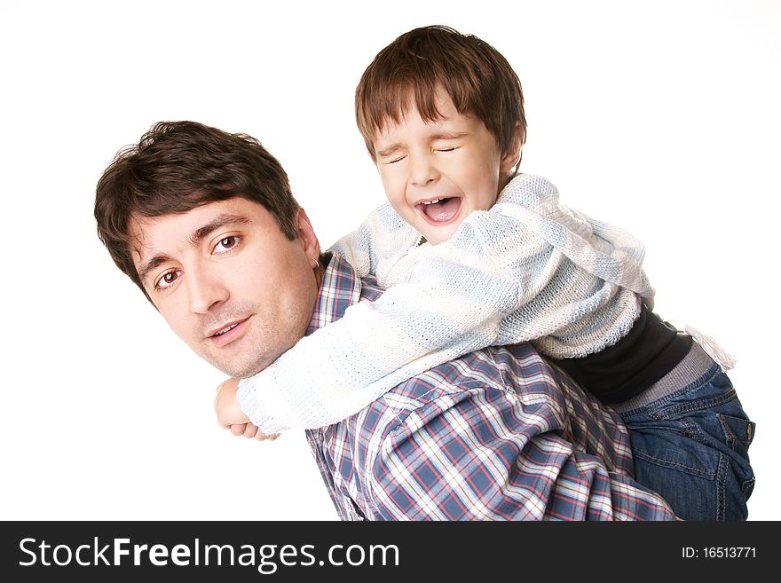 Portrait of young attractive smiling father playing with his little joyful son on white background. Portrait of young attractive smiling father playing with his little joyful son on white background