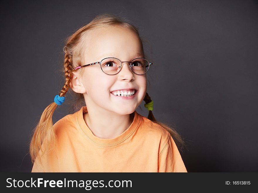 Portrait of happy joyful girl in glasses looking up, studio shot. Portrait of happy joyful girl in glasses looking up, studio shot