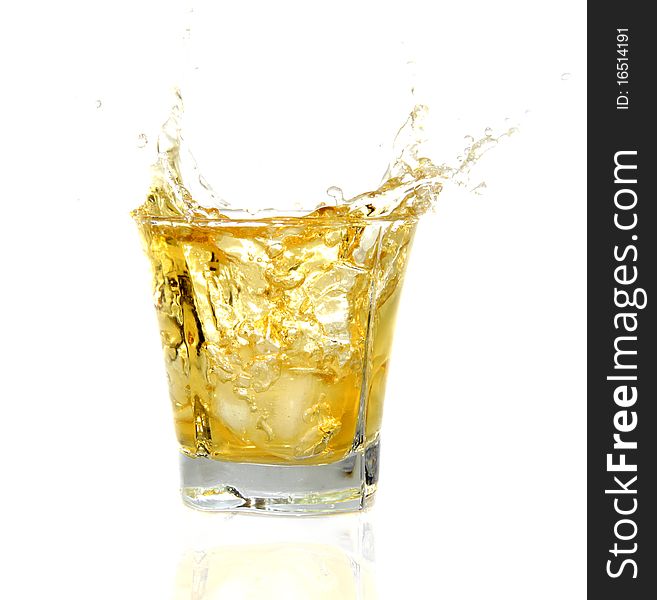 GLass with Whiskey splashing out, isolated on white background