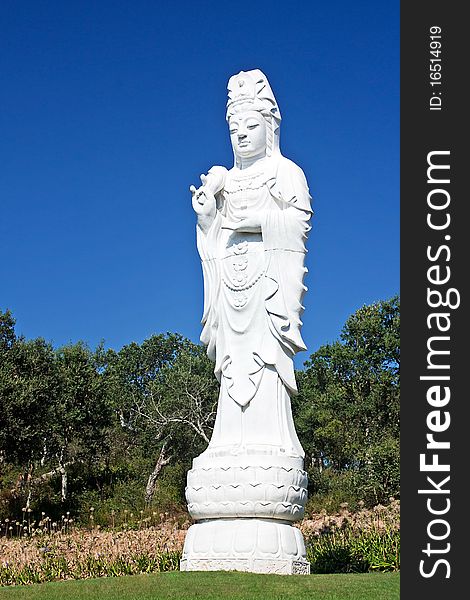 Statue of white stone standing buddha