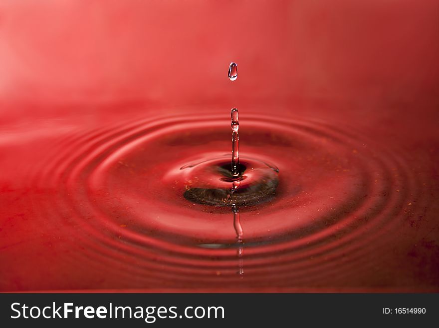 Drop of water on red