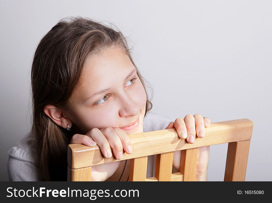 Portrait of a teenage girl sitting on a chair. Portrait of a teenage girl sitting on a chair