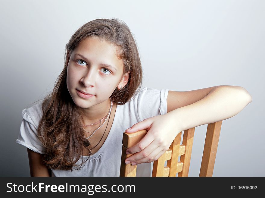 Portrait of a teenage girl sitting on a chair. Portrait of a teenage girl sitting on a chair