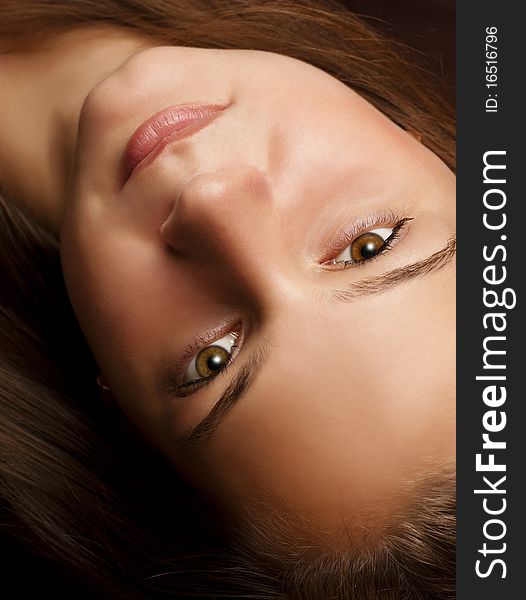 Portrait of a beautiful young girl upside down on a dark background. Portrait of a beautiful young girl upside down on a dark background.