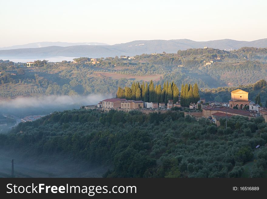 Fog burns off a hillside near Siena, in the Tuscany region of Italy. Fog burns off a hillside near Siena, in the Tuscany region of Italy