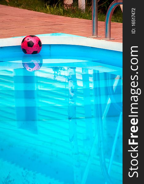 Ball is floating in pool near house