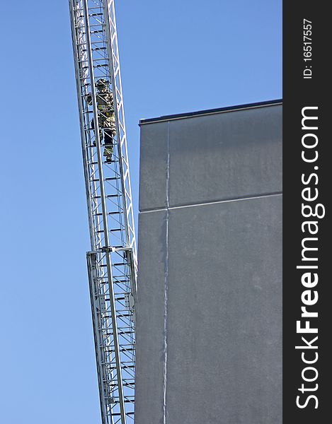 Firefighter climbing an aerial ladder