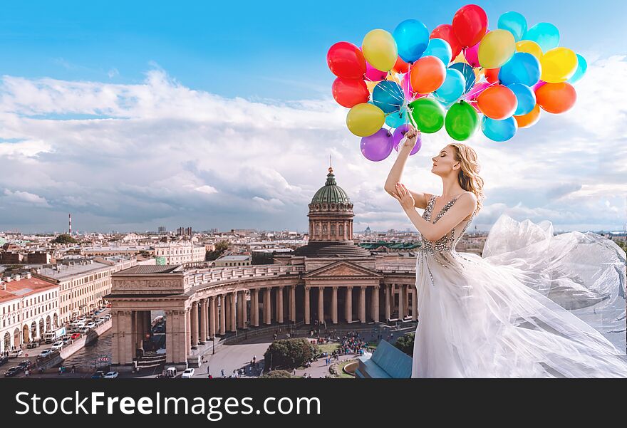 Woman with balloons in a waved dress on the background of St. Petersburg, Russia. Kazan Cathedral