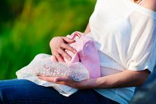 Pregnant Woman With First Cloth For Newborn Baby Royalty Free Stock Photography