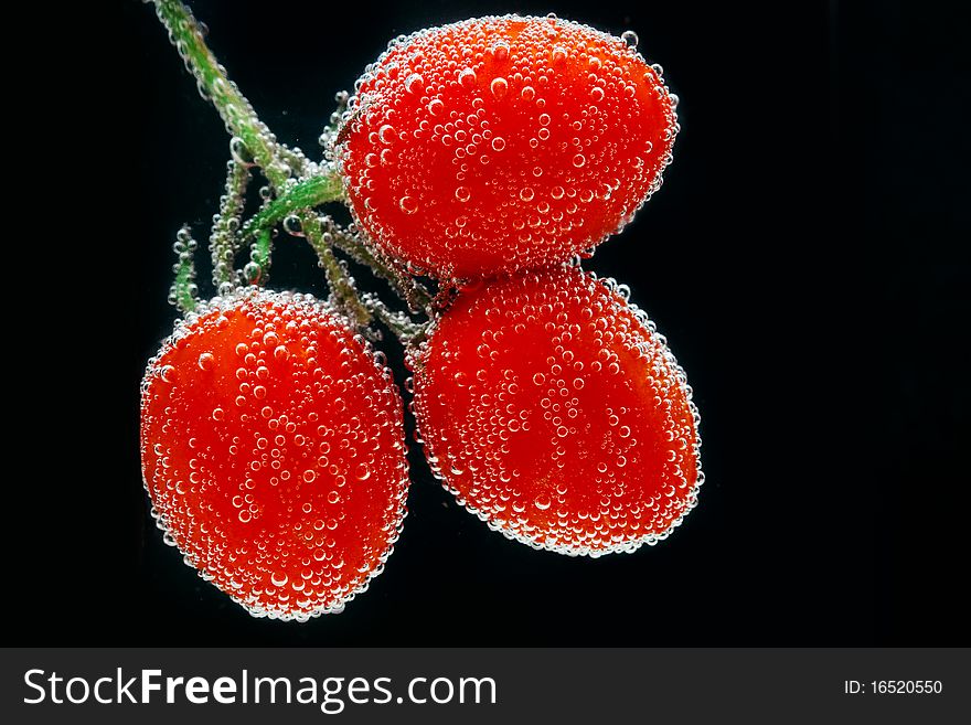 Three beautiful fresh tomato in water