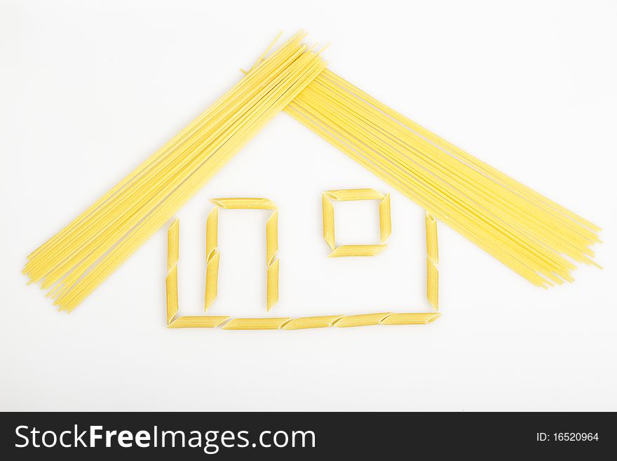 House built with a cylindrical and pasta noodles on a white background. House built with a cylindrical and pasta noodles on a white background