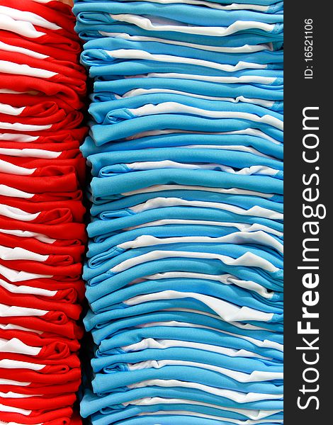 Stacks of red and light blue T-shirts. Stacks of red and light blue T-shirts