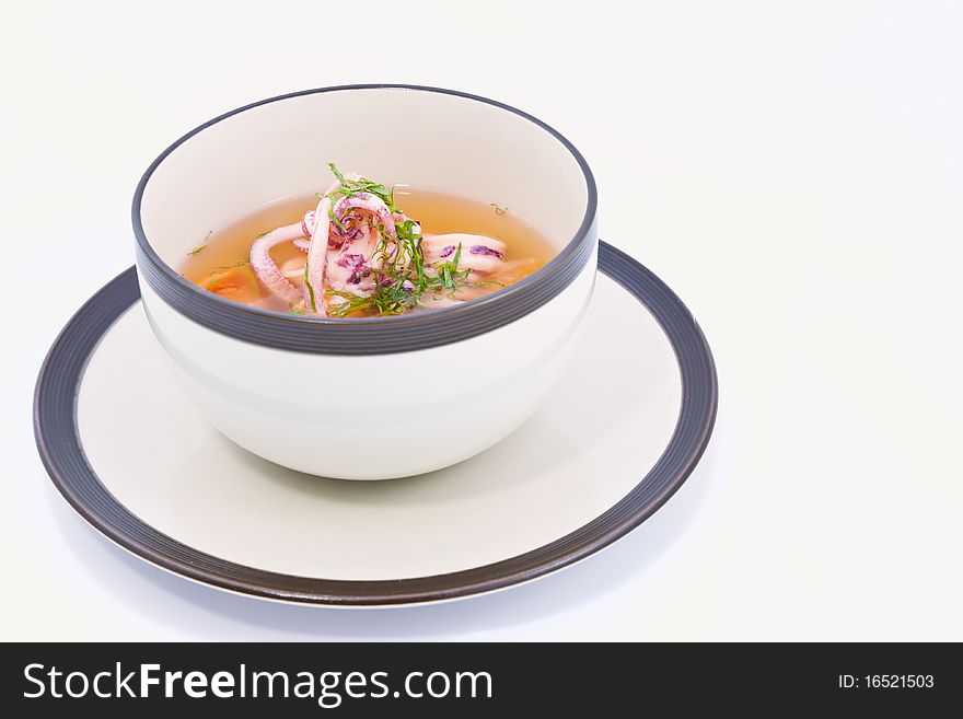 A flavorsome squid soup in white bowl