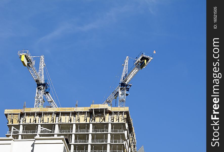 Two cranes atop new construction