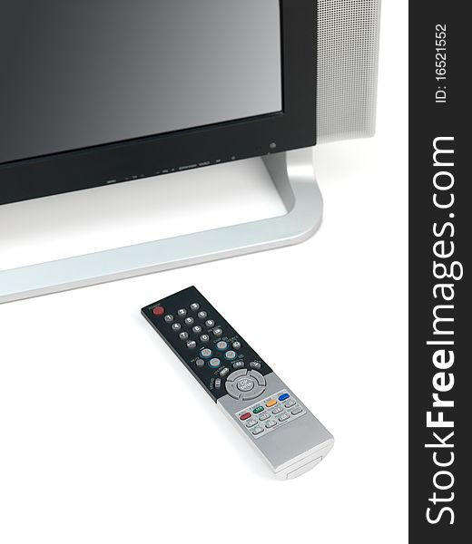 A LCD TV monitor and remote control isolated against a white background