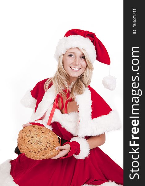 A female dressed like Santa with a big cookie. A female dressed like Santa with a big cookie.