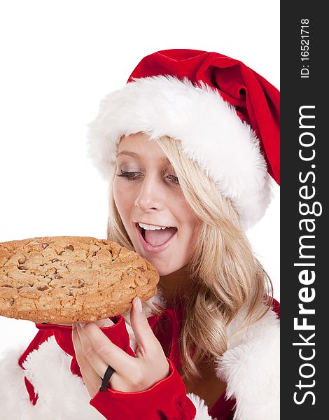 A female dressed like Santa with a big cookie. A female dressed like Santa with a big cookie.