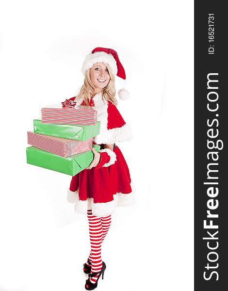 A female dressed like santa holding some presents. A female dressed like santa holding some presents.