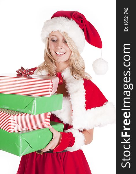 A female dressed like santa holding some presents. A female dressed like santa holding some presents.