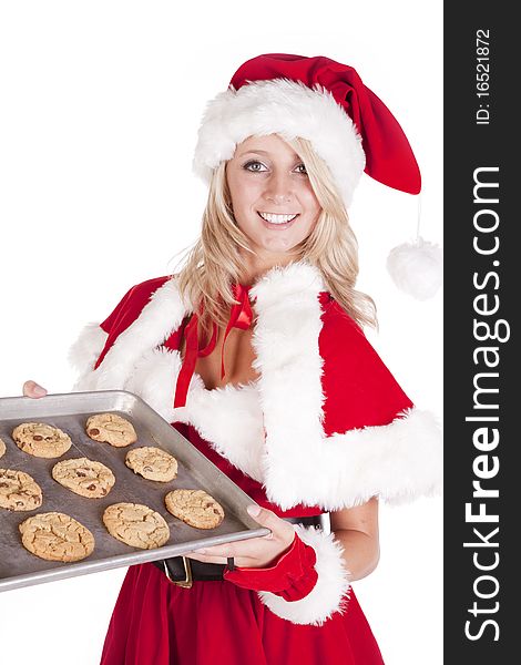 A female dressed like Santas helper is holding a pan of freshly baked cookies. A female dressed like Santas helper is holding a pan of freshly baked cookies.