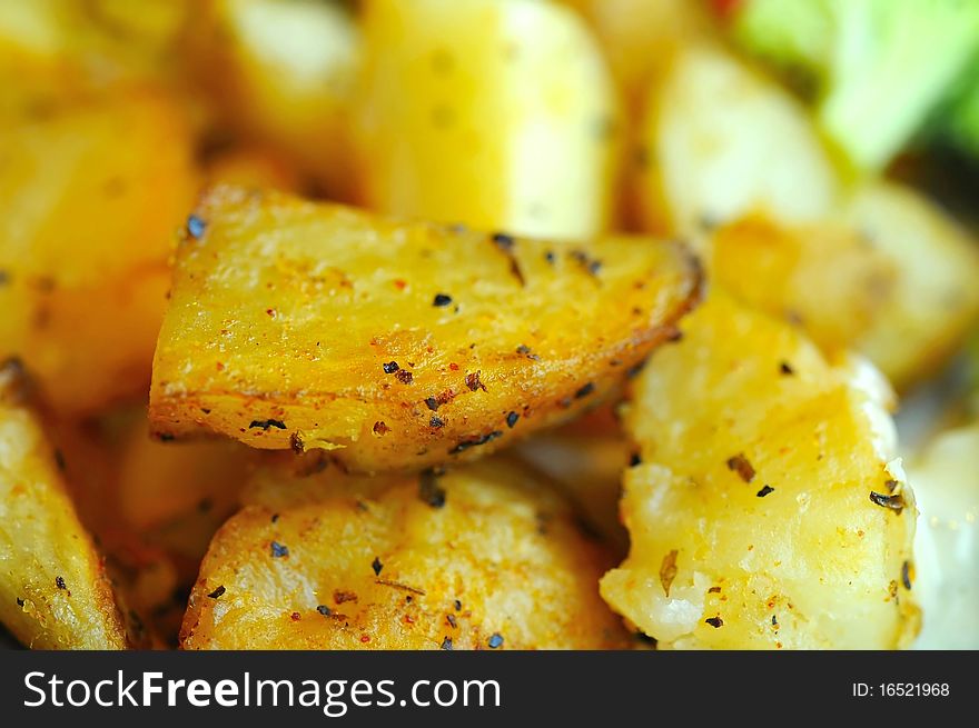 Macro shot of seasoned potatos grilled western style. Macro shot of seasoned potatos grilled western style.