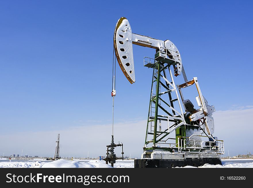 Cold winter, oil producing equipment is covered with snow. Cold winter, oil producing equipment is covered with snow