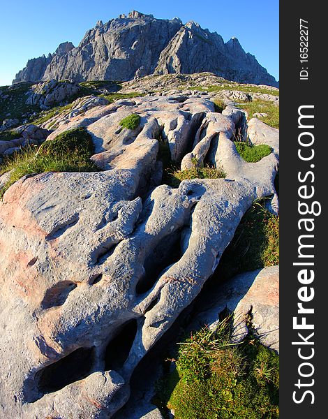 Limestone structure with rocky peaks in the background. Limestone structure with rocky peaks in the background