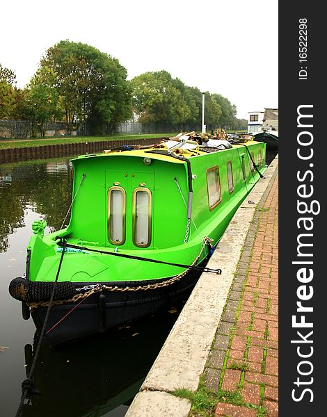 Image of a green painted canal boat in London. Image of a green painted canal boat in London