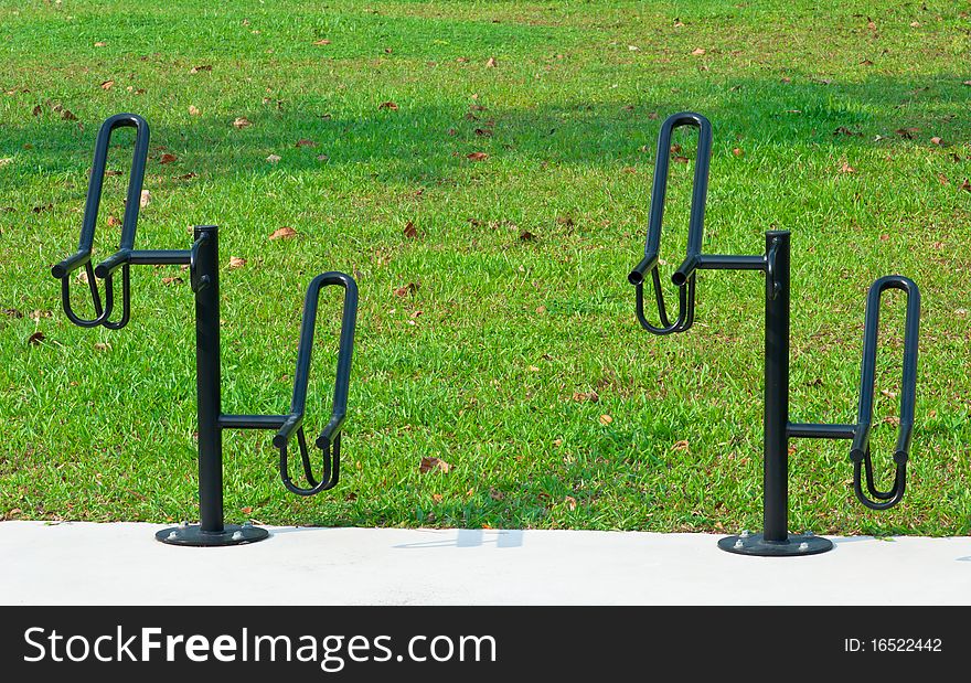 Black Colored Bicycle Racks with Green Grass background. Black Colored Bicycle Racks with Green Grass background