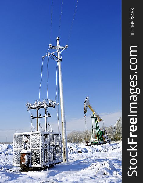 Cold winter, oil producing equipment is covered with snow. Cold winter, oil producing equipment is covered with snow