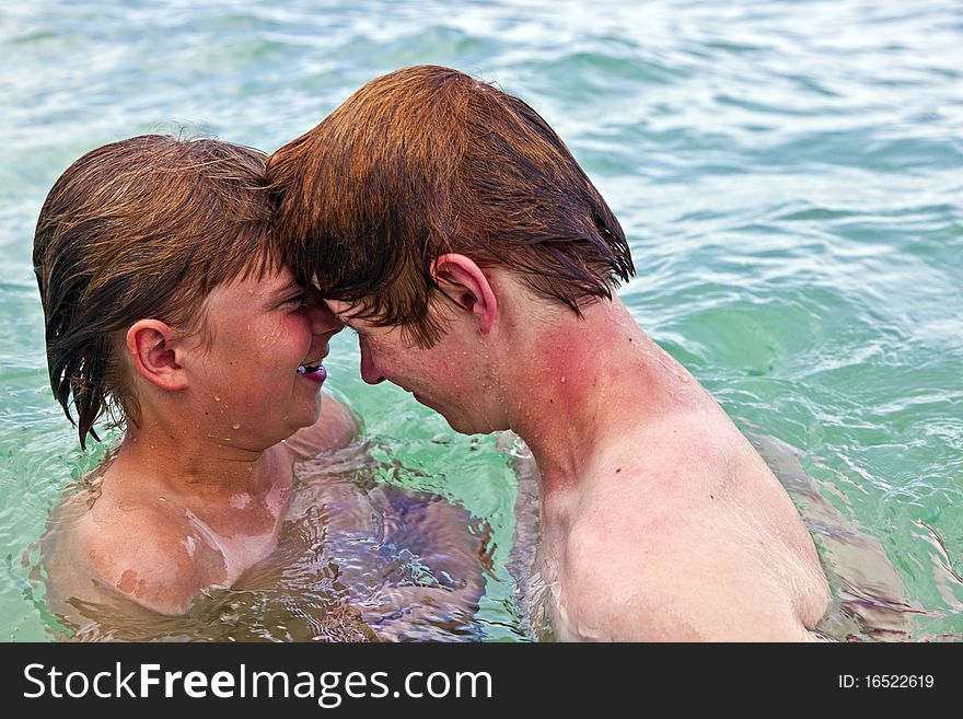 Boys Having Fun In The Clear Sea