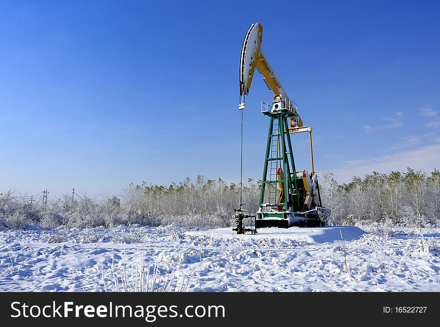 Cold winter, oil producing equipment is covered with snow. Cold winter, oil producing equipment is covered with snow