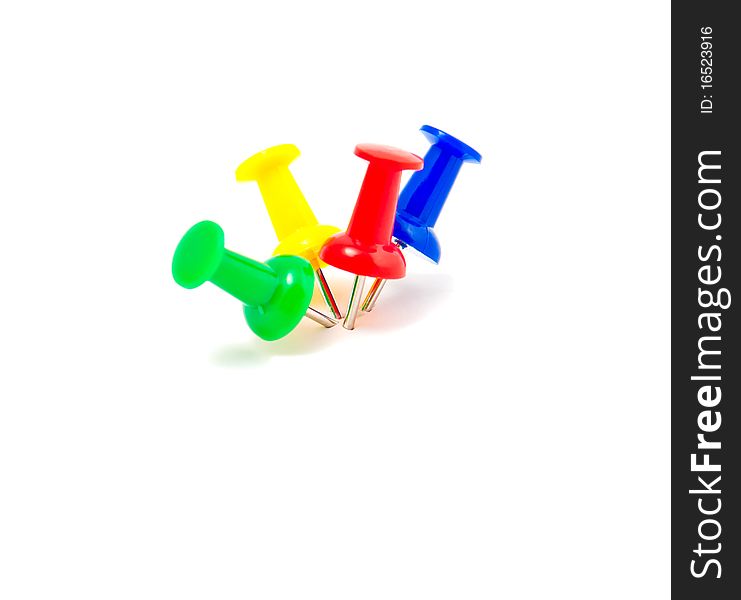 Colorful push pins arranged on white background