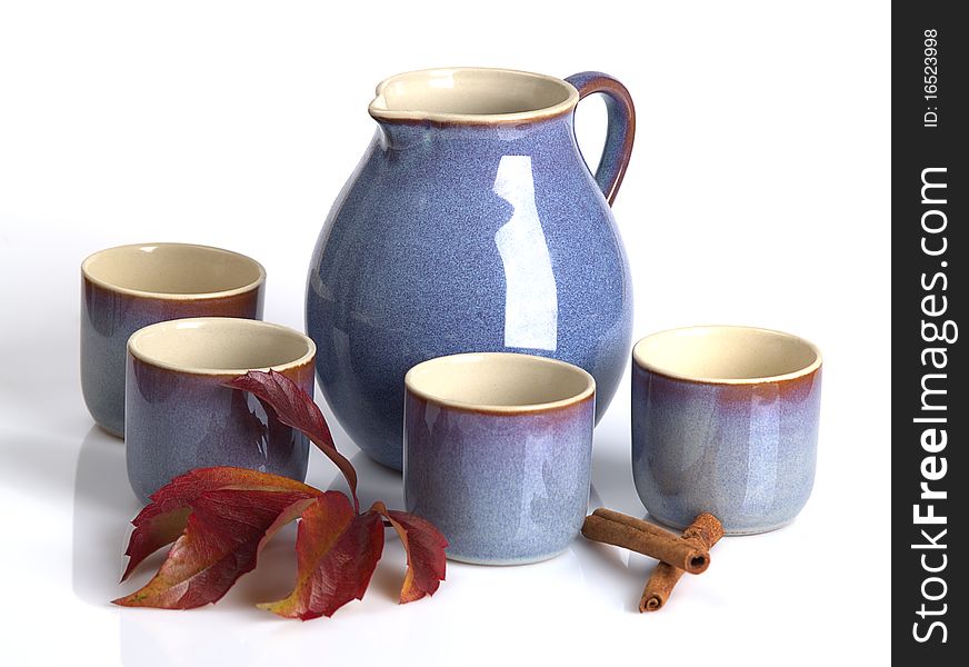 The photo shows a teapot and some teacups over white. The photo shows a teapot and some teacups over white